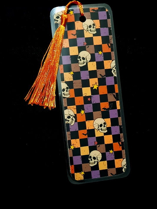 Retro checkered Halloween bookmark featuring skulls, bats and stars. Laminated with a tassel. 