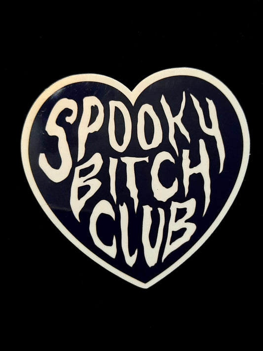 Heart-shaped sticker with 'Spooky Bitch Club' text on a black background